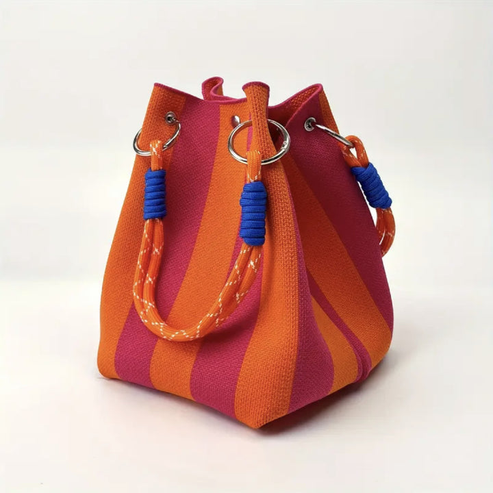 Woven bucket bag in orange and pink striped knit design with rope handle